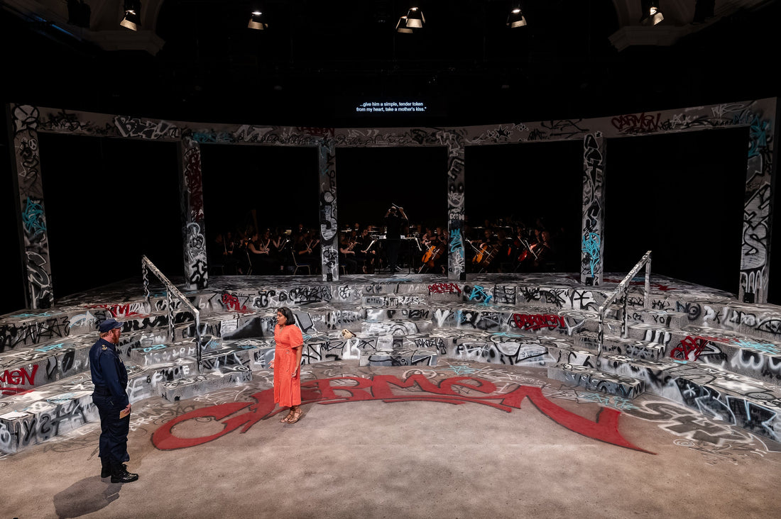 The graffiti-covered Carmen set at Blackheath Halls during the performance, with the red Carmen piece across the stage floor